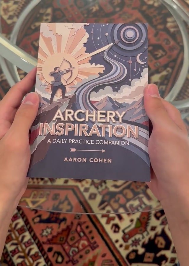 A copy of Archery Inspiration held in two hands